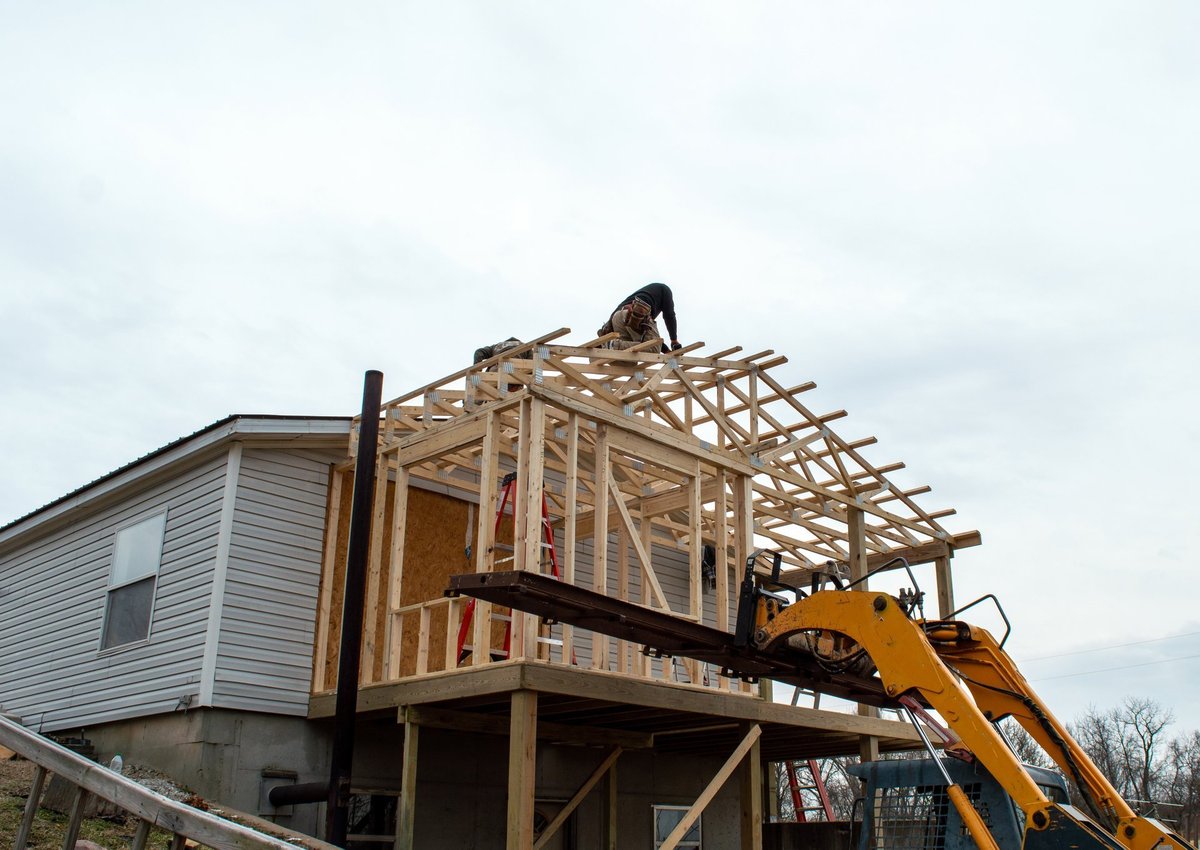 Professional construction team working on home addition roof
