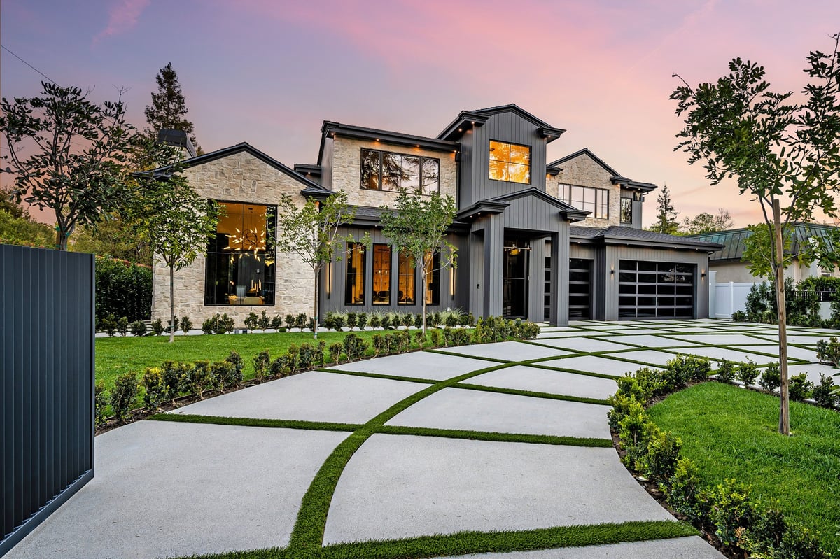 Modern luxury home exterior with landscaped property