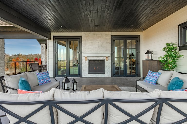 Balcony deck patio with covered area, patio furniture and fireplace with autumn mountain view